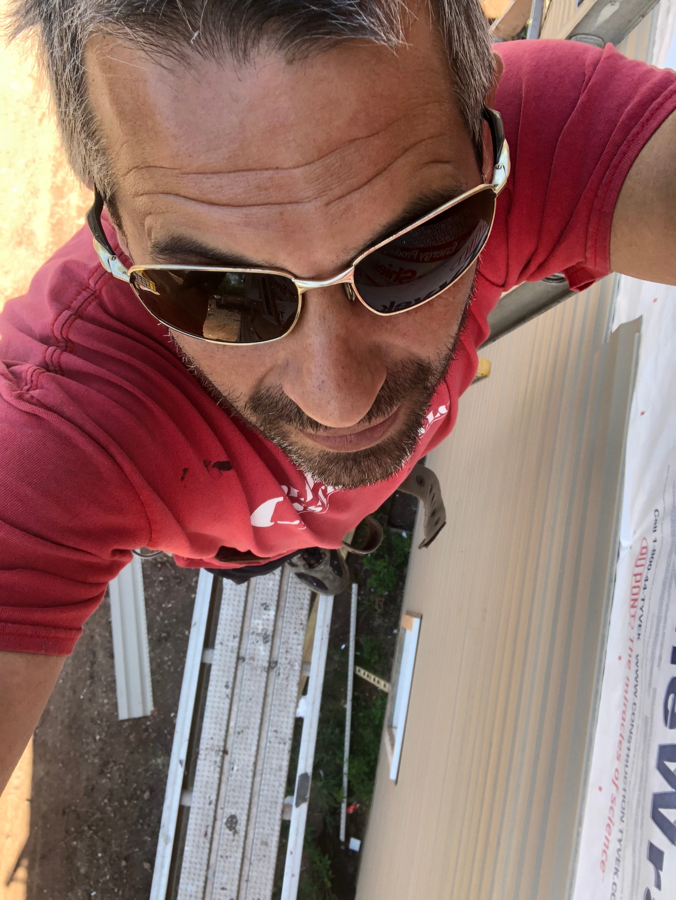 Collegeville Construction owner installing siding on the job